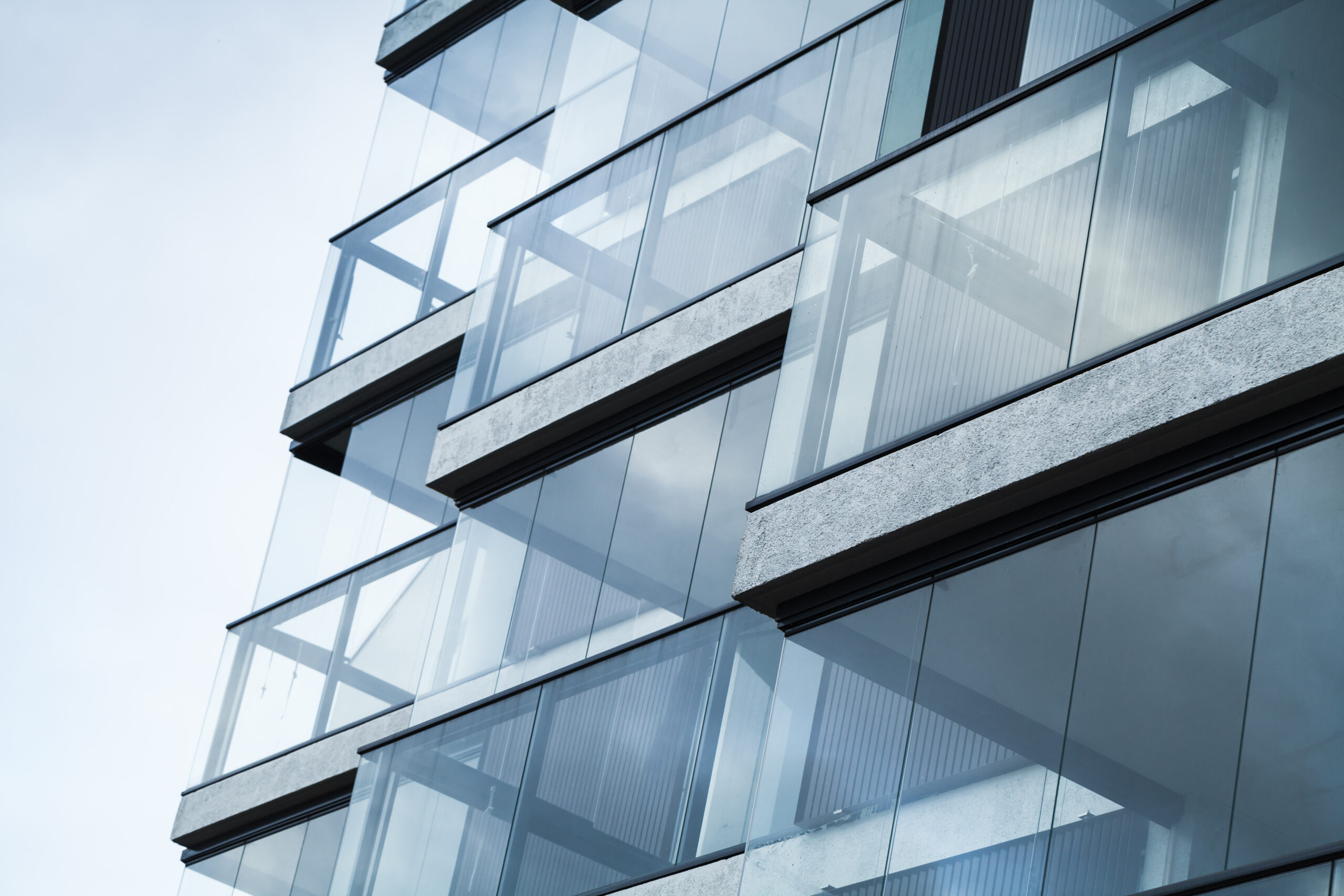 Abstract fragment of modern architecture walls made of glass and concrete